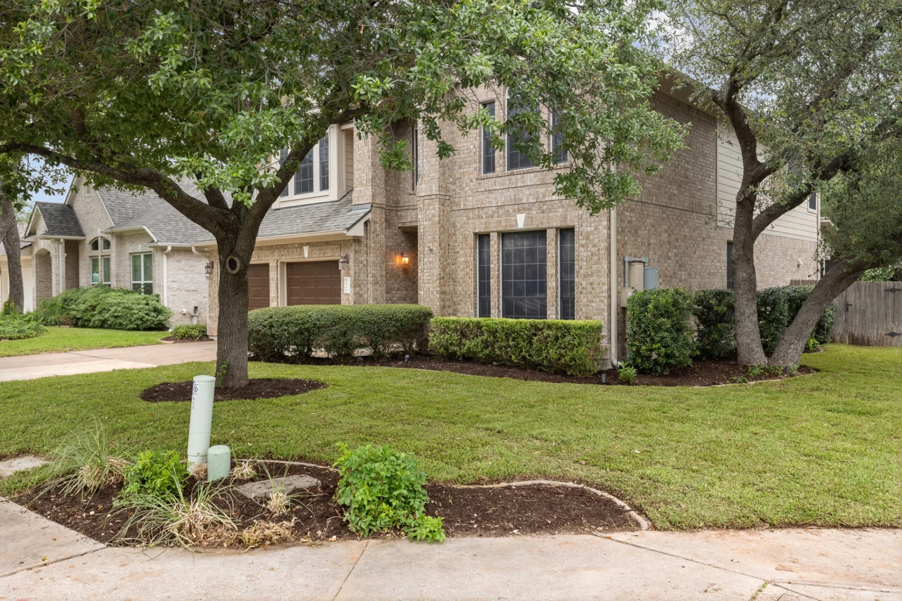 Side angle showing tree canopy and landscaping