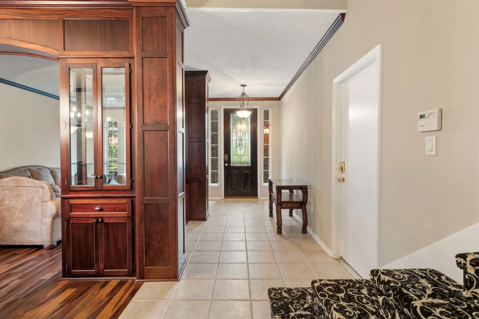 Entry hallway with custom cherry built-ins and front door