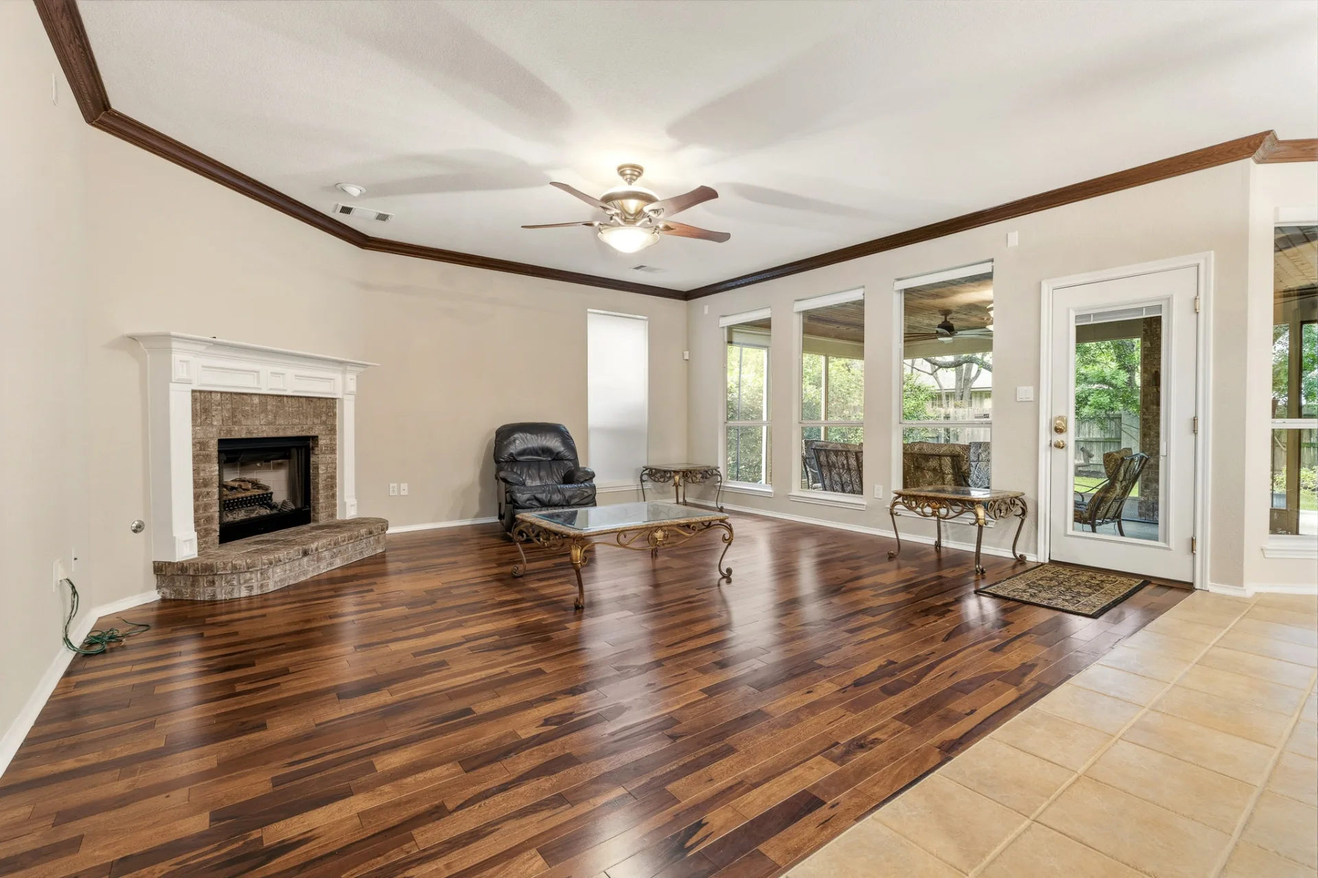 Family room with brick fireplace and tigerwood floors