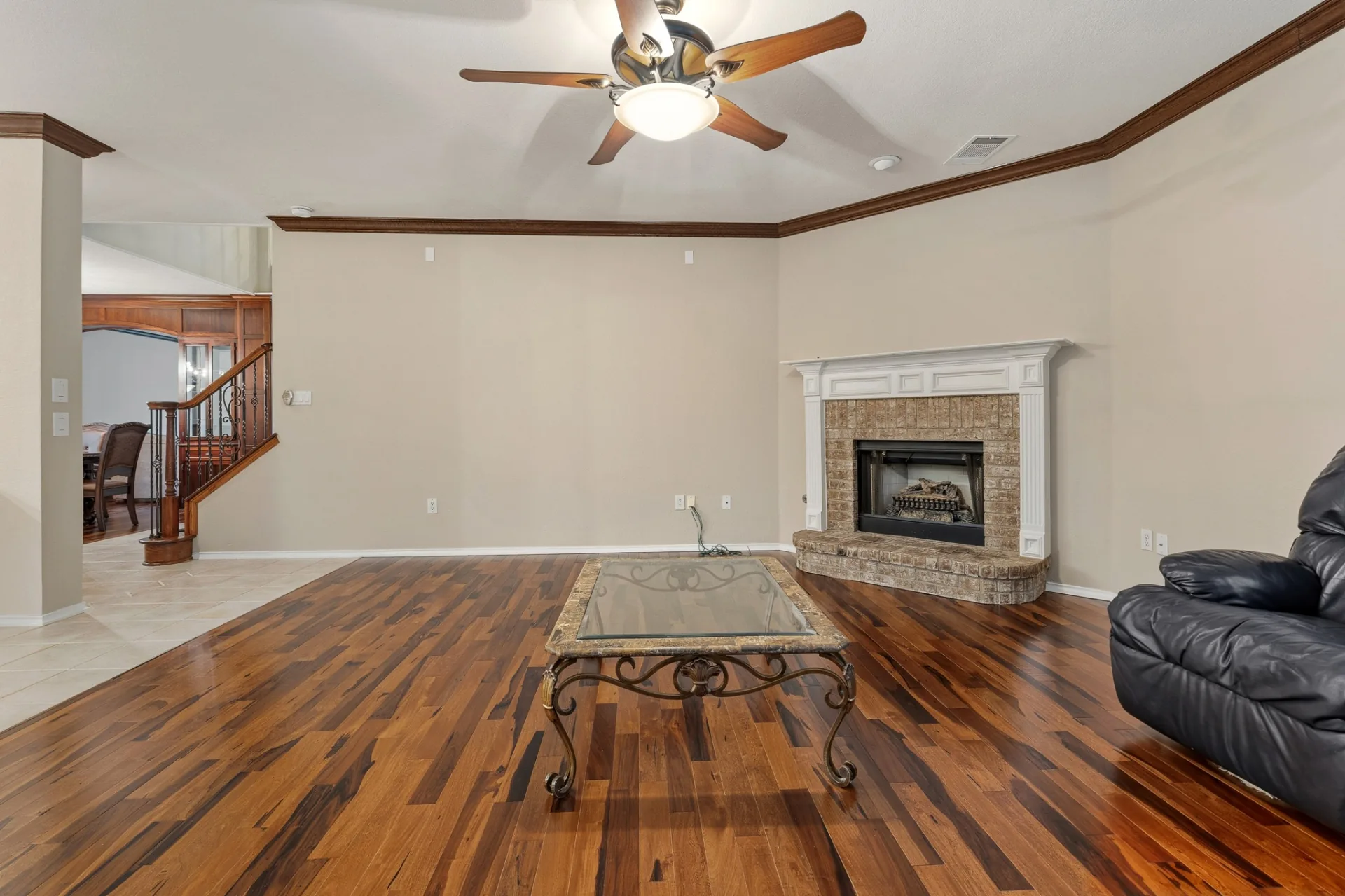 Family room wide view with fireplace and staircase