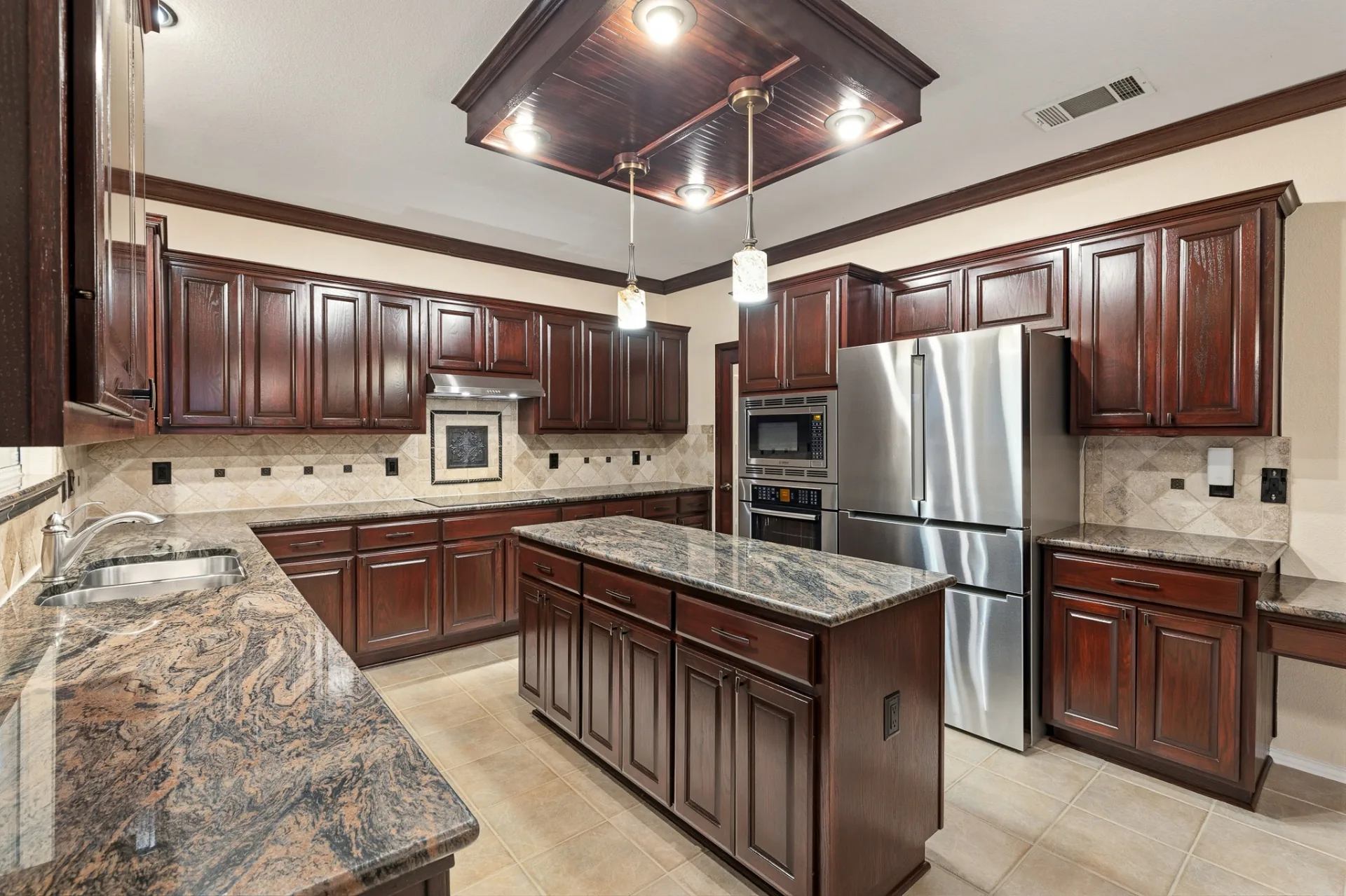 Kitchen island with abundant prep space and surrounding cabinetry