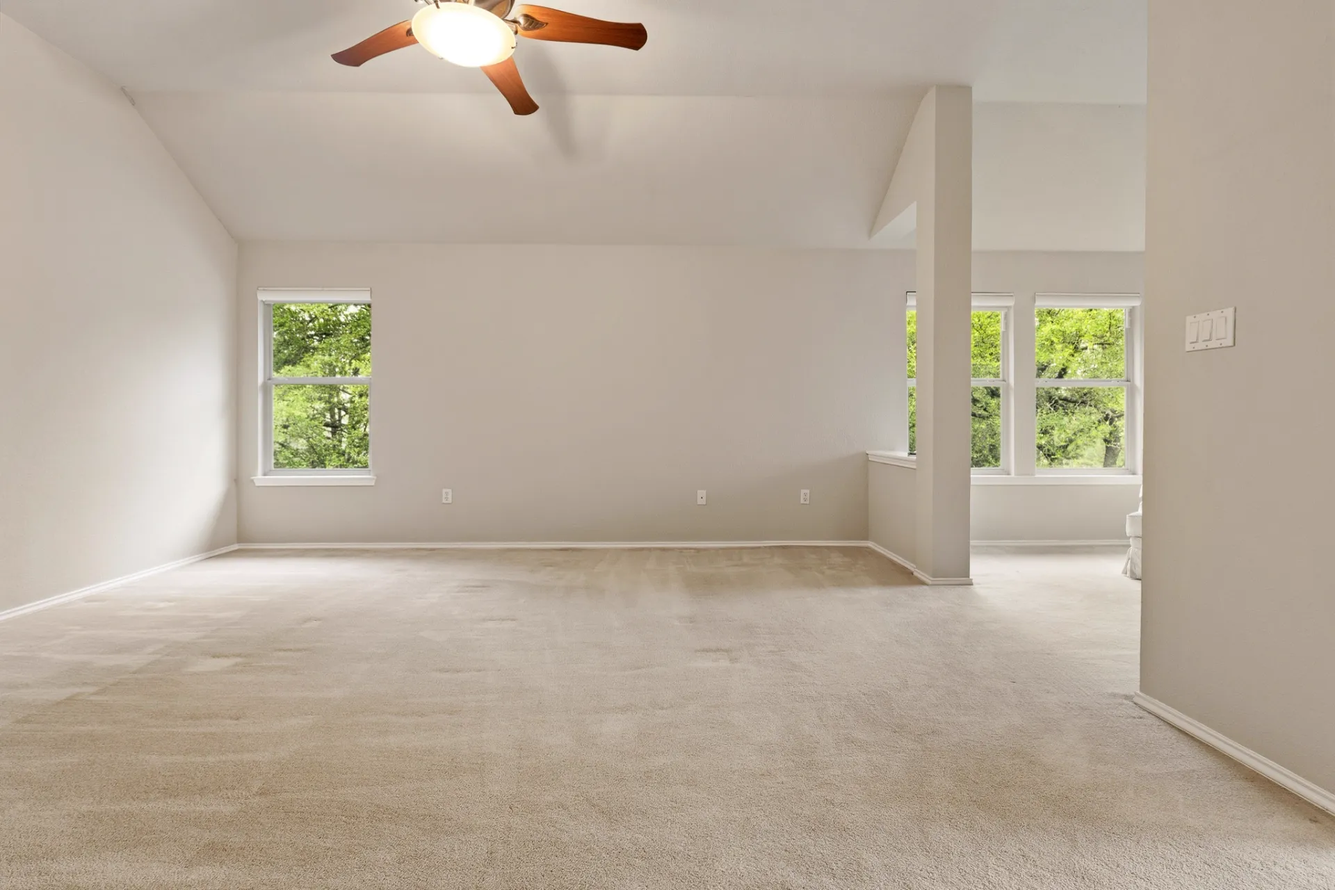 Primary bedroom with vaulted ceiling and sitting nook
