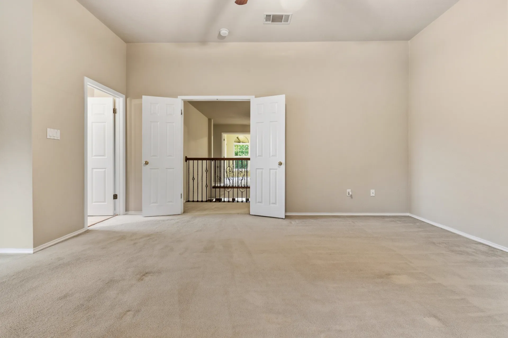 Upstairs bonus room with double-door entry overlooking the foyer