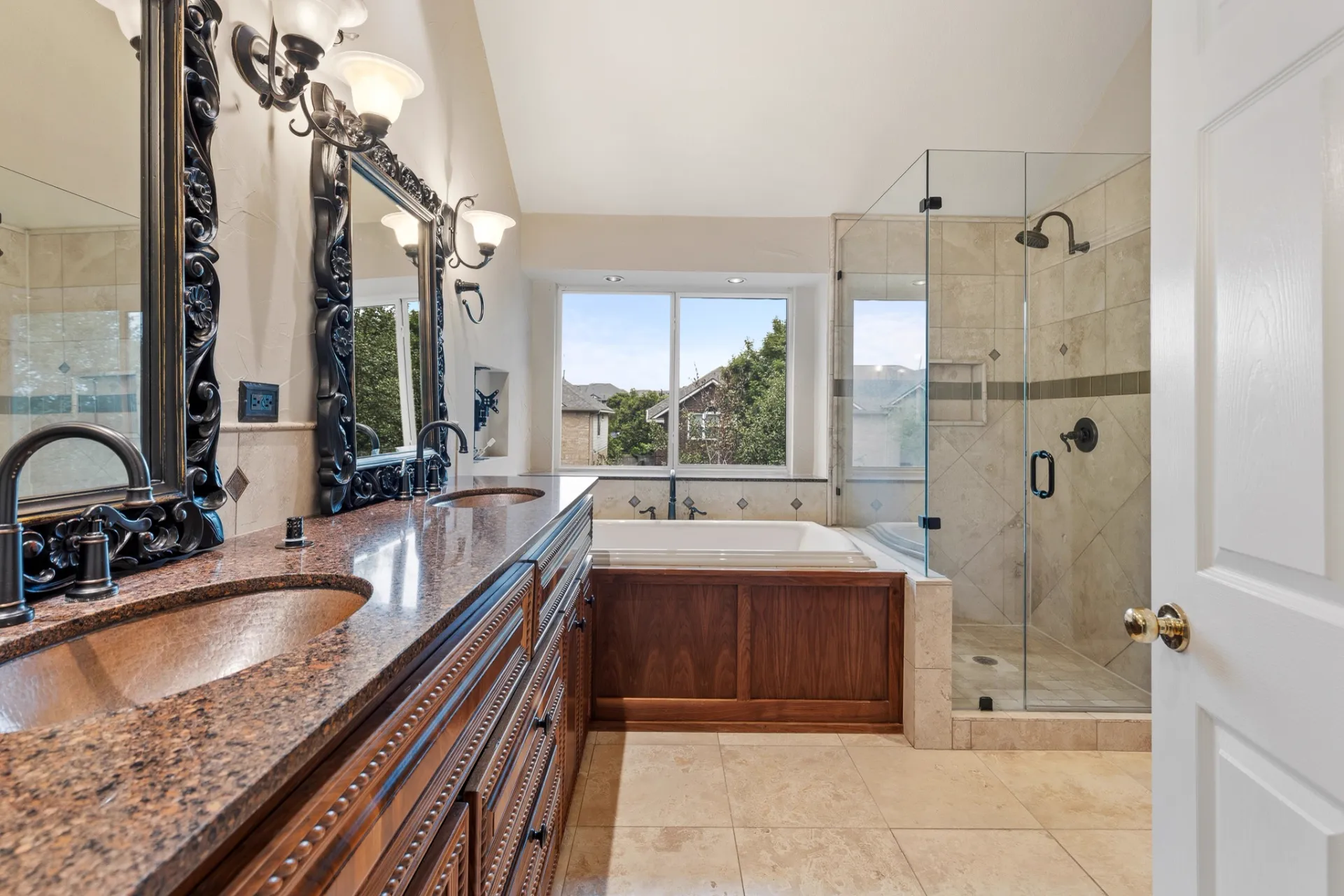 Primary bathroom with double vanity, soaking tub, and walk-in shower