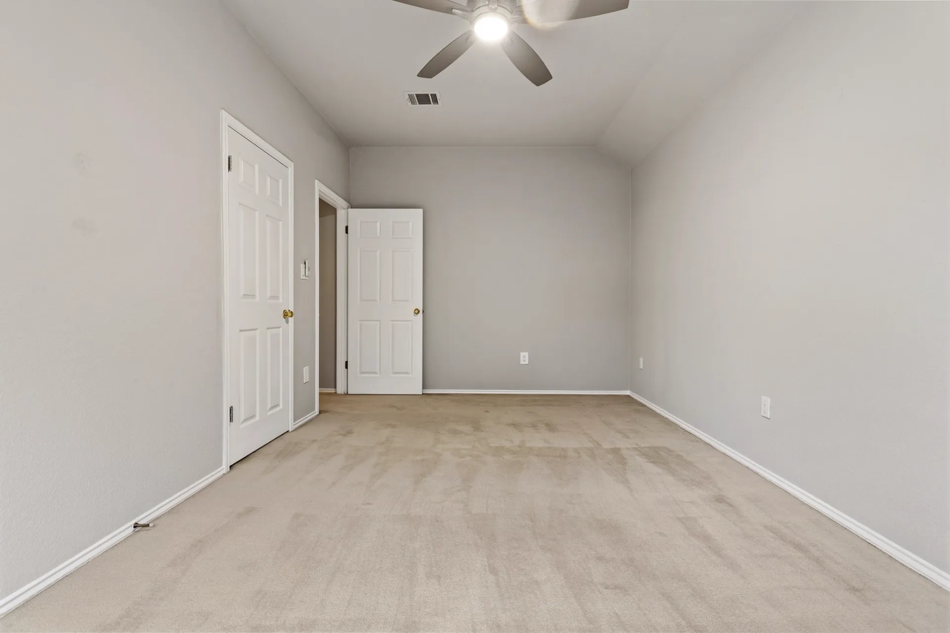 Bedroom with vaulted ceiling and walk-in closet