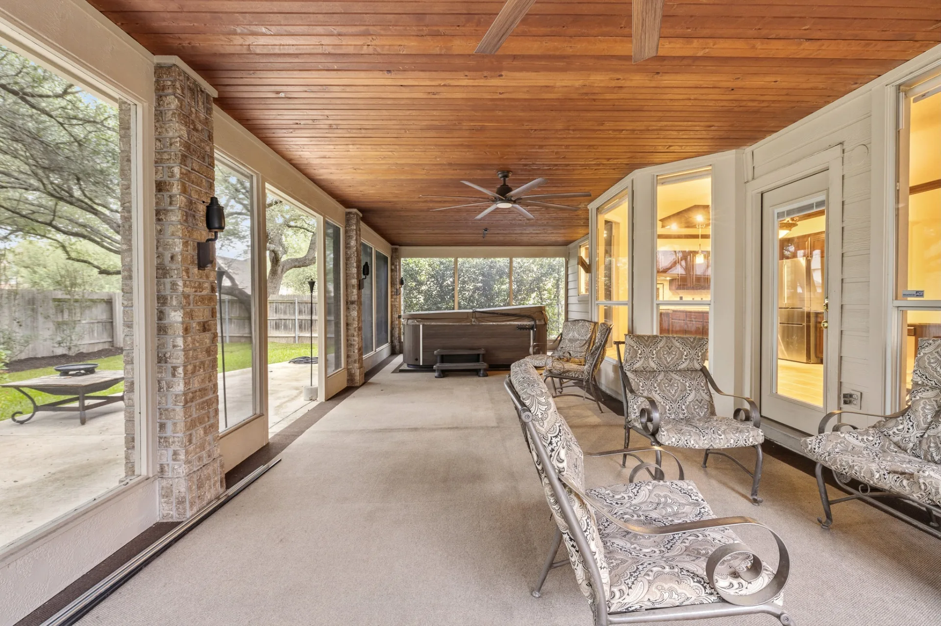 Screened-in patio with cedar plank ceiling and ceiling fans