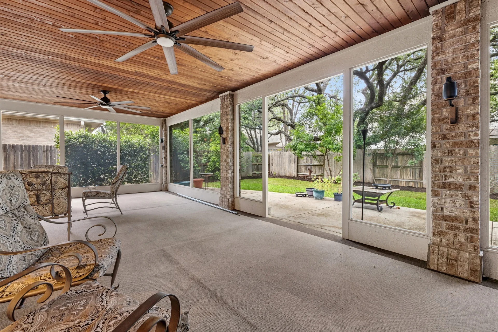Screened patio seating area with views to the backyard